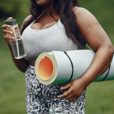 Rolled yoga mat and a water bottle nearby.